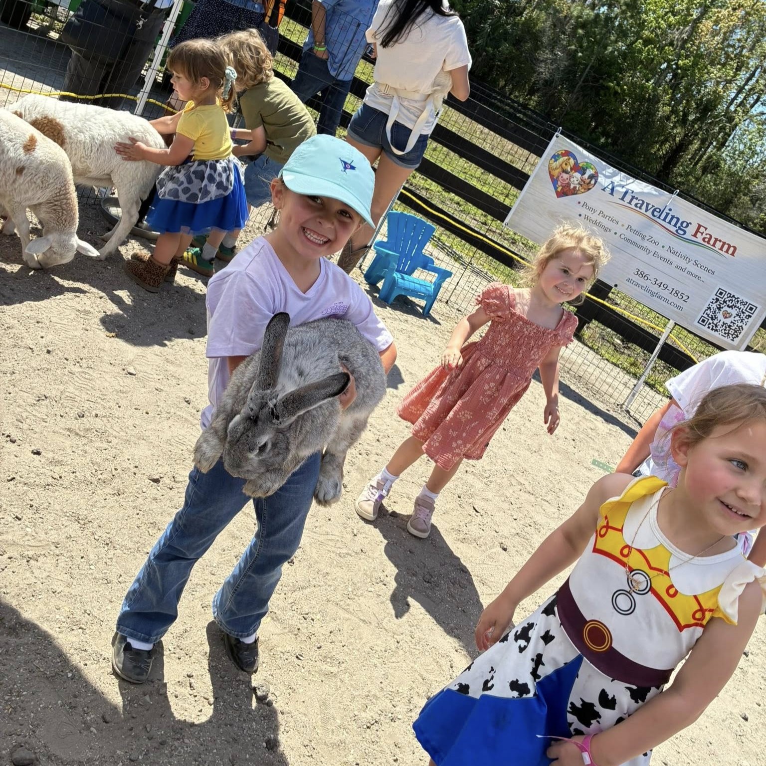 Child holding a baby lamb at A Traveling Farm mobile petting zoo Port Orange FL